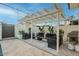 Outdoor living area with comfortable lounge seating under a stylish pergola at 4132 N 34Th Pl, Phoenix, AZ 85018