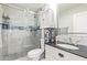 Bathroom featuring a glass-door shower with gray tile, white vanity with black countertop at 4857 N Granite Reef Rd, Scottsdale, AZ 85251