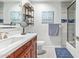 Bright bathroom with wood-look vanity and white countertop, a mirror, and glass door shower at 4857 N Granite Reef Rd, Scottsdale, AZ 85251