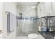 Bathroom featuring a glass-door shower with gray tile, white vanity with black countertop at 4857 N Granite Reef Rd, Scottsdale, AZ 85251