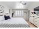 Bedroom boasts a window with white shutters, ceiling fan, and a white storage cabinet at 4857 N Granite Reef Rd, Scottsdale, AZ 85251