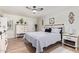 Bright bedroom features a ceiling fan, wood floors, and a stylish white storage cabinet at 4857 N Granite Reef Rd, Scottsdale, AZ 85251