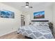 Bedroom with hard surface floors, ceiling fan, artwork, and access to an ensuite bath at 4857 N Granite Reef Rd, Scottsdale, AZ 85251