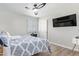 Cozy bedroom featuring hard floors, modern ceiling fan, and bright natural light through shutters at 4857 N Granite Reef Rd, Scottsdale, AZ 85251