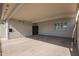 Carport area of property with black door and light colored siding and brick at 4857 N Granite Reef Rd, Scottsdale, AZ 85251