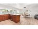 Open concept dining area with modern light fixture sits adjacent to a kitchen with an island and sleek appliances at 4857 N Granite Reef Rd, Scottsdale, AZ 85251