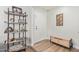 Inviting foyer showcases wood floors, stylish bench, and decorative shelving near the white front door at 4857 N Granite Reef Rd, Scottsdale, AZ 85251