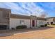 Quaint townhouse boasts tidy landscaping and a striking maroon front door with modern accents at 4857 N Granite Reef Rd, Scottsdale, AZ 85251