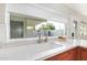 Bright kitchen sink area offering counter space with modern fixtures and a view to the outdoors at 4857 N Granite Reef Rd, Scottsdale, AZ 85251