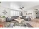 Bright living room features a large sectional, modern ceiling fan, and lots of natural light at 4857 N Granite Reef Rd, Scottsdale, AZ 85251