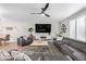 Bright living room showcasing an open concept to the dining area, sectional sofa and entertainment center at 4857 N Granite Reef Rd, Scottsdale, AZ 85251