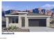 New construction exterior elevation with stone veneer and desert landscaping with mountain backdrop at 4939 S 105Th Dr, Tolleson, AZ 85353