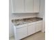 A kitchen featuring bright white cabinets, and gray and white granite countertops at 4939 S 105Th Dr, Tolleson, AZ 85353