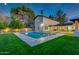 Inviting backyard with a sparkling pool and lush landscaping, perfect for outdoor living at 5020 E Pershing Ave, Scottsdale, AZ 85254