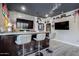 Finished basement bar area with brick wall and TV at 5020 E Pershing Ave, Scottsdale, AZ 85254