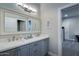 Bathroom featuring double sinks, granite countertops, updated fixtures, and a shower-tub combo at 5020 E Pershing Ave, Scottsdale, AZ 85254