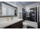 Modern bathroom with a granite countertop vanity, updated fixtures, and a glass-enclosed shower at 5020 E Pershing Ave, Scottsdale, AZ 85254