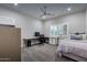 Bedroom with a ceiling fan, desk/work space, neutral walls and carpet, and plantation shutters at 5020 E Pershing Ave, Scottsdale, AZ 85254