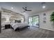 Modern primary bedroom with wood-paneled accent wall and sliding door to the outdoor patio at 5020 E Pershing Ave, Scottsdale, AZ 85254