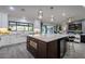 Open-concept kitchen featuring a large island with marble countertops and pendant lighting at 5020 E Pershing Ave, Scottsdale, AZ 85254