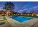 Backyard view featuring a rectangular pool, covered patio with outdoor seating, and mature trees at 5020 E Pershing Ave, Scottsdale, AZ 85254