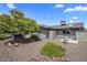 Landscaped backyard featuring a covered hot tub, storage shed, garden boxes, and drought-tolerant landscaping at 5061 E Edgewood Ave, Mesa, AZ 85206