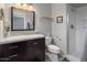 Bathroom featuring dark wood vanity, mirror, shower, toilet, and stylish decor at 5061 E Edgewood Ave, Mesa, AZ 85206