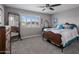 Bedroom featuring a wooden bed frame, carpet flooring, and a window with shutters at 5061 E Edgewood Ave, Mesa, AZ 85206