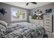 Bright bedroom featuring a window, stylish decor, and a comfortable bed with a unique pattern at 5061 E Edgewood Ave, Mesa, AZ 85206