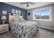 Charming bedroom featuring a decorative blue accent wall, soft gray carpet, and window letting in natural light at 5061 E Edgewood Ave, Mesa, AZ 85206