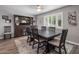 Dining room with dark wood table, six chairs, hutch, and plantation shutters at 5061 E Edgewood Ave, Mesa, AZ 85206