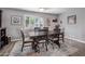 Dining room with dark wood table, six chairs, rug, and plantation shutters at 5061 E Edgewood Ave, Mesa, AZ 85206