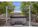 Modern hot tub beneath a pergola, offering a private spa experience in a serene backyard setting at 5061 E Edgewood Ave, Mesa, AZ 85206