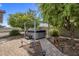 Backyard hot tub featuring an attractive pergola and a well-maintained paver stone walkway at 5061 E Edgewood Ave, Mesa, AZ 85206