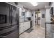 Well-lit kitchen with stainless steel appliances and white cabinets at 5061 E Edgewood Ave, Mesa, AZ 85206