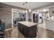 Kitchen island featuring dark wood cabinets, seating, and pendant lighting at 5061 E Edgewood Ave, Mesa, AZ 85206