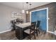 Kitchen island with granite countertop, dark wood cabinets, pendant lighting, and wood-paneled wall at 5061 E Edgewood Ave, Mesa, AZ 85206