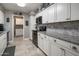 Modern kitchen featuring white cabinets, stainless steel hardware and appliances, granite counters, and decorative backsplash at 5061 E Edgewood Ave, Mesa, AZ 85206