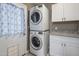 Efficient laundry area with stacked washer/dryer units and a granite-top utility counter for added functionality at 5061 E Edgewood Ave, Mesa, AZ 85206