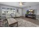 Comfortable living room with a ceiling fan, TV, and a cozy rug at 5061 E Edgewood Ave, Mesa, AZ 85206