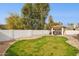 Spacious backyard featuring a white wall, well-kept lawn, and shaded gazebo with outdoor furniture at 510 S Kenwood Ln, Chandler, AZ 85226