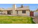 Back exterior of house featuring a chimney, small patio, and well-maintained green lawn at 510 S Kenwood Ln, Chandler, AZ 85226