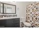 Modern bathroom featuring patterned shower curtain, single sink vanity, and tile backsplash at 510 S Kenwood Ln, Chandler, AZ 85226