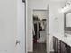 Ensuite bathroom with walk-in closet featuring modern vanity and tile flooring at 510 S Kenwood Ln, Chandler, AZ 85226