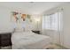 Well-lit bedroom with a large window, accent art, and neutral carpet at 510 S Kenwood Ln, Chandler, AZ 85226