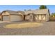 Single-story home features gravel landscaping and a large window with white horizontal blinds at 510 S Kenwood Ln, Chandler, AZ 85226