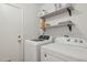 Well-lit laundry room with shelving, modern washer and dryer, and access door to the exterior at 510 S Kenwood Ln, Chandler, AZ 85226