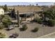 Expansive aerial shot showcasing the backyard with desert landscaping, covered patio, and neighborhood views at 5450 N Globe Dr, Eloy, AZ 85131