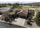 Aerial view of single-story home with tile roof, three-car garage, and backyard golf course view at 5450 N Globe Dr, Eloy, AZ 85131