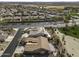 Wide aerial view of the neighborhood, featuring a home with solar panels, desert landscaping, and a covered patio at 5450 N Globe Dr, Eloy, AZ 85131